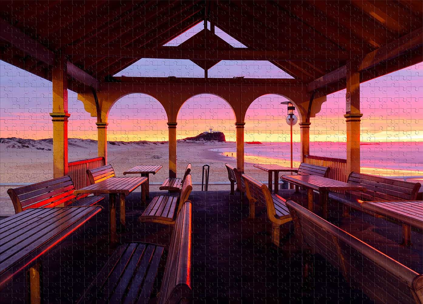 1000-piece Nobbys Pavilion Newcastle jigsaw puzzle featuring a colourful sunrise over Nobbys Beach and Nobbys Lighthouse