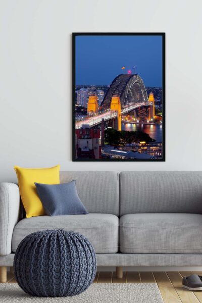 Framed photograph of the Sydney Harbour Bridge in blue dusk tones displayed as modern coastal wall art.