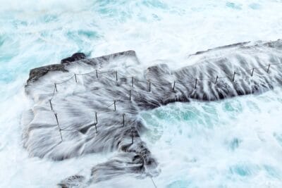 Long-exposure seascape of the Bogey Hole in Newcastle NSW with smooth water and soft morning light