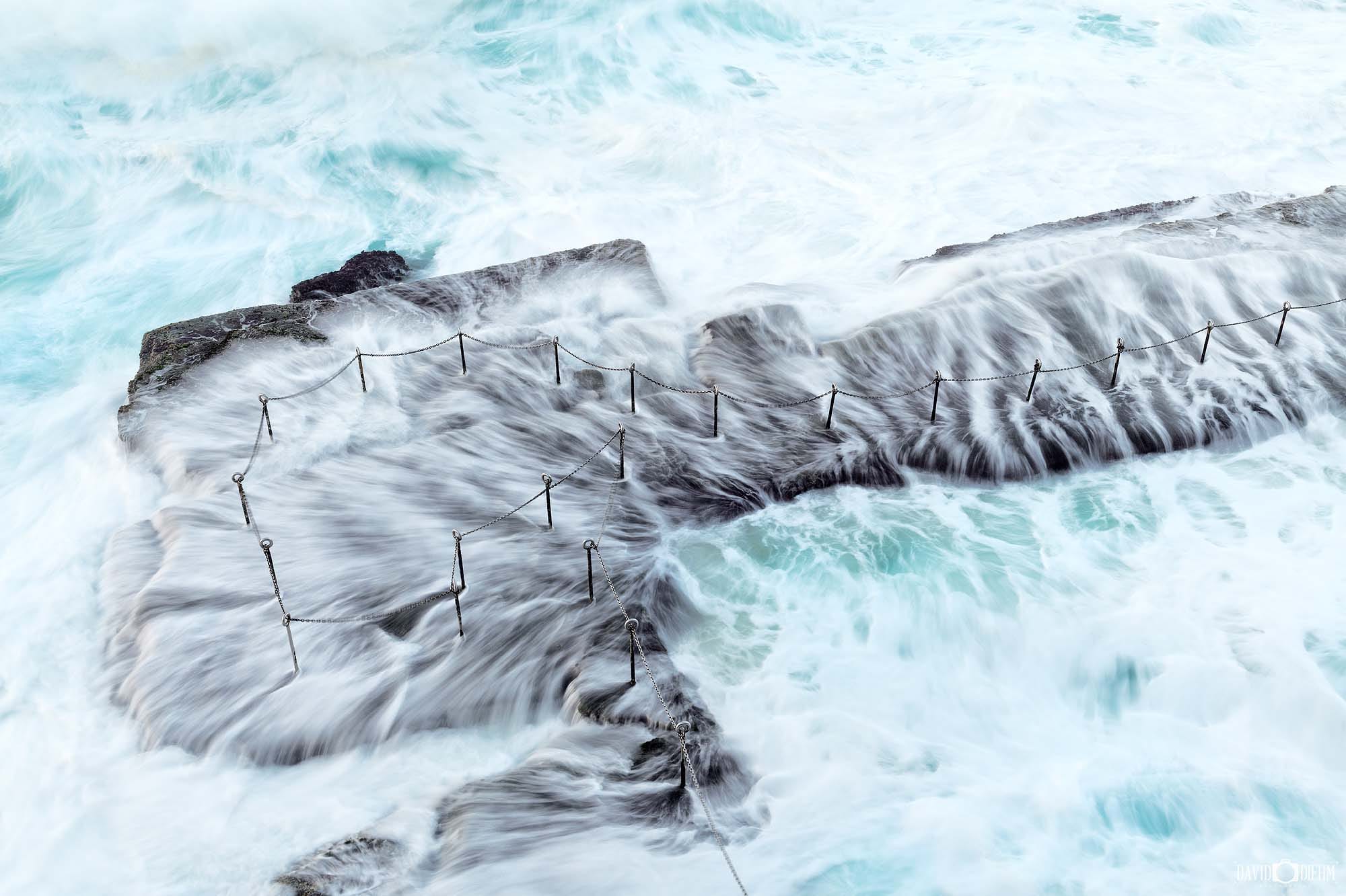 Long-exposure seascape of the Bogey Hole in Newcastle NSW with smooth water and soft morning light