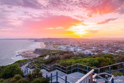 Golden sunset over ANZAC Memorial Walk overlooking Bar Beach and Newcastle's coastline in NSW.
