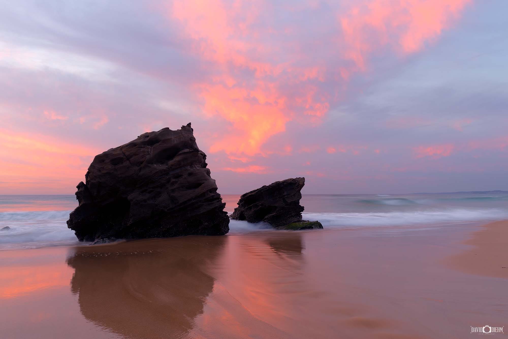 Sunset light illuminating the rocky shoreline at Redhead Beach on the NSW coast.