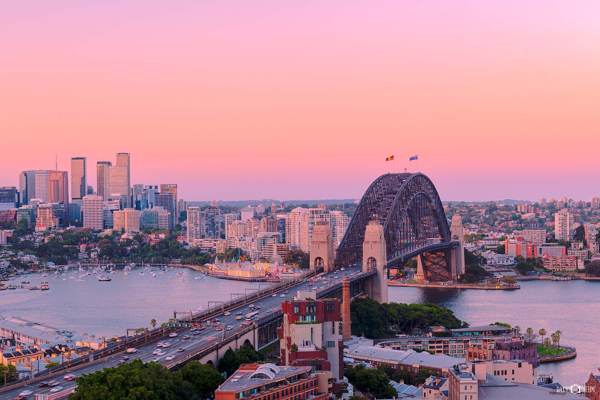 Framed photograph of the Sydney Harbour Bridge at sunset displayed as modern coastal wall art.
