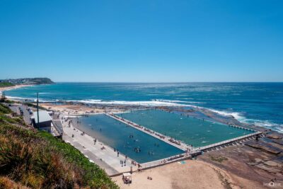 Elevated view of Merewether Ocean Baths looking north on a perfect summer day with blue skies