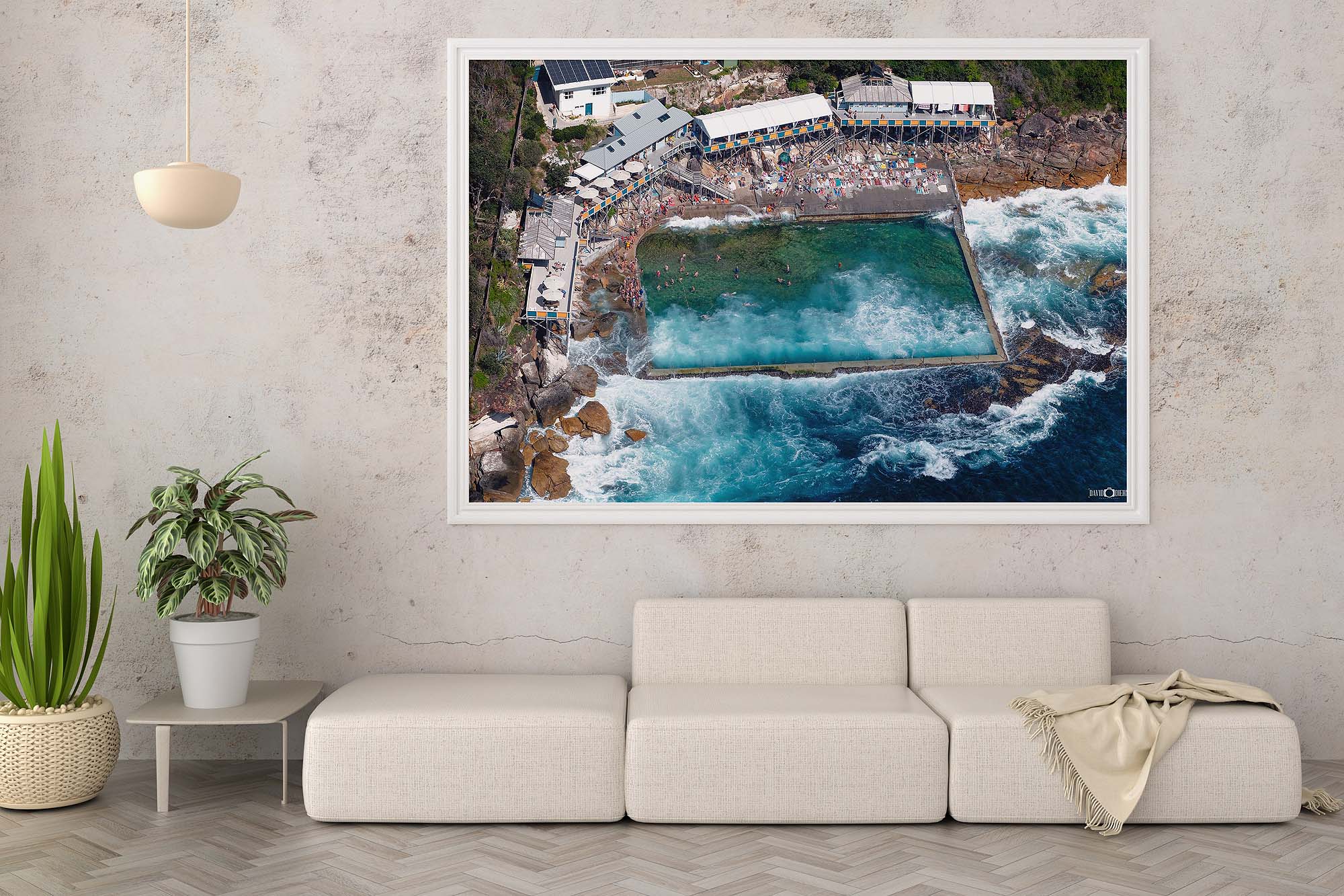 Framed aerial photograph of Wylie’s Baths displayed as modern coastal wall art in an interior setting.
