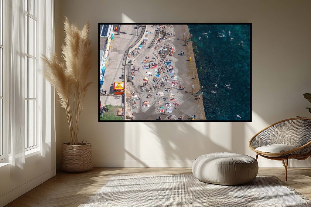 Drone perspective of Clovelly Beach in Sydney highlighting the rock formations, ocean pool, and turquoise water from a unique angle.
