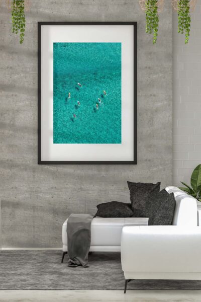 Framed aerial photograph of surfboards floating in turquoise water at Bondi Beach displayed as modern coastal wall art.