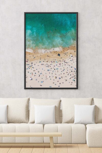 Framed aerial photograph of Bondi Beach with people enjoying the beach, styled as modern coastal wall art.