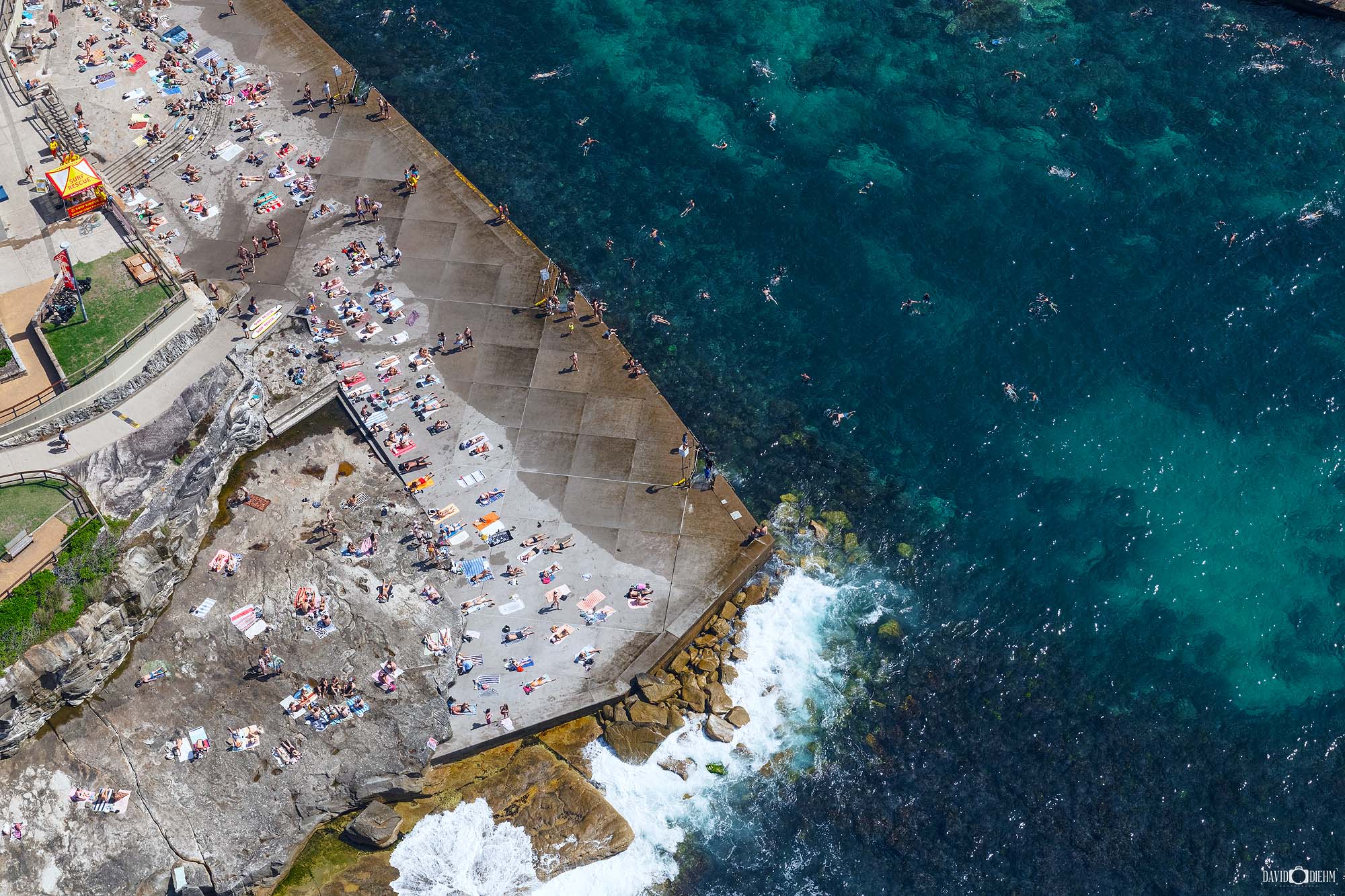 Aerial photograph of the rocky coastline and natural rock formations at Clovelly Beach in Sydney, Australia.