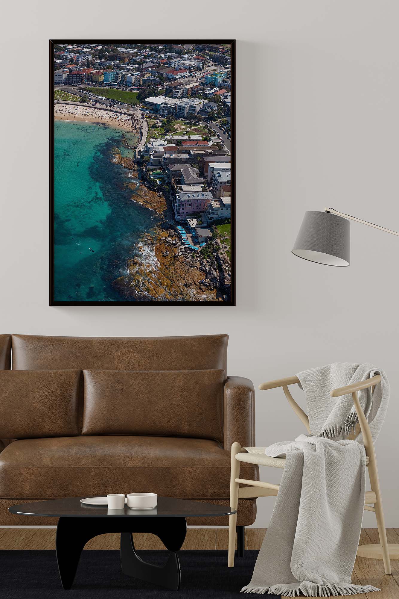 Framed aerial photograph of North Bondi Beach displayed as modern coastal wall art in a contemporary interior.