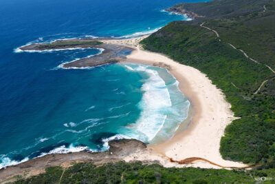 Moonee Beach NSW captured from above in clear summer conditions with turquoise water and beach landscape