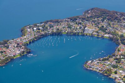 Wangi Wangi in Lake Macquarie captured from the air during daytime showing coastal peninsula and waterfront