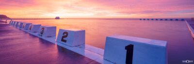Sunrise at Merewether Ocean Baths with textured concrete blocks in the foreground, Newcastle NSW