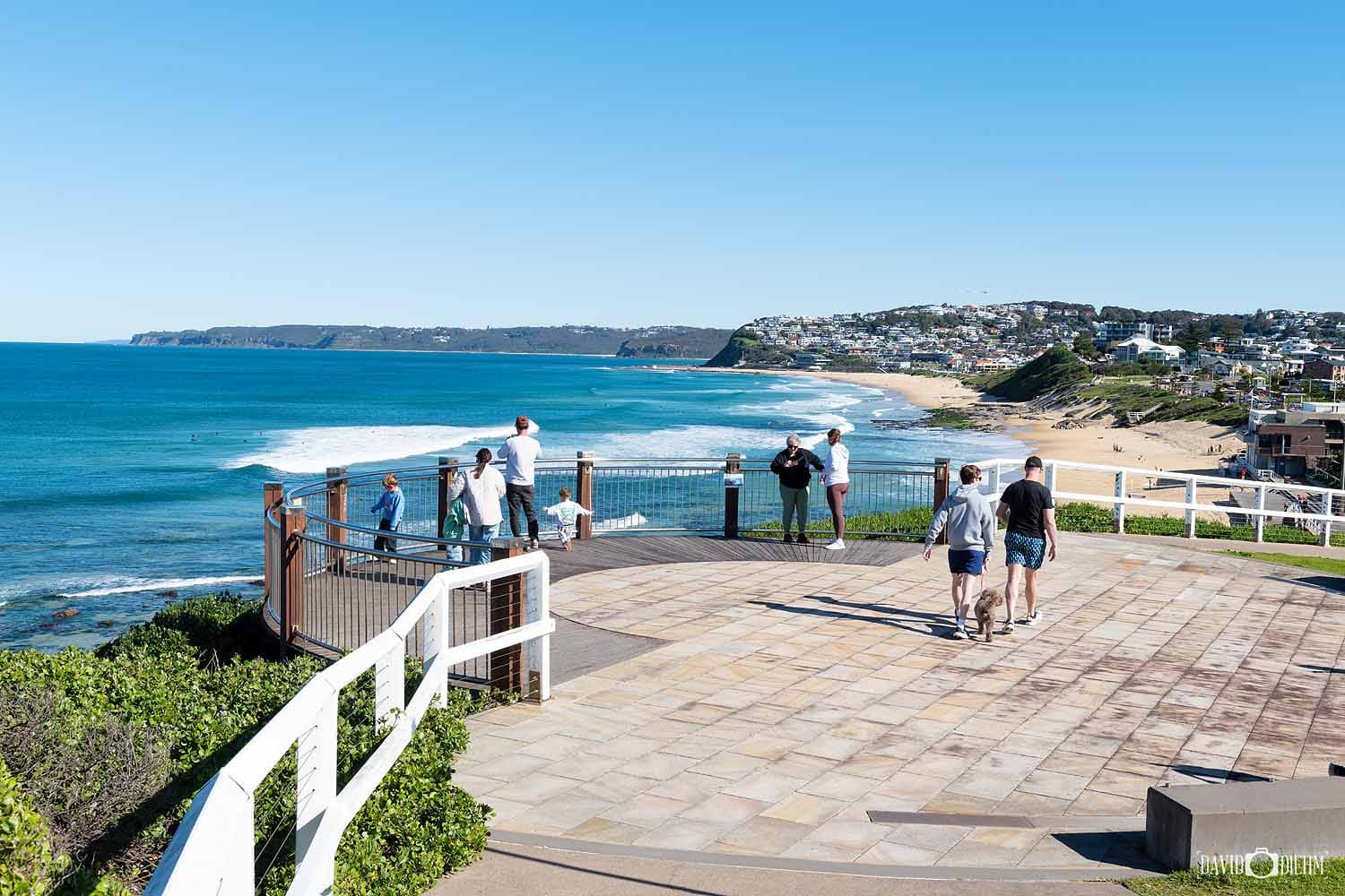 Visitors enjoying the views from Bar Beach Lookout overlooking Bar Beach and Merewether Beach in Newcastle.