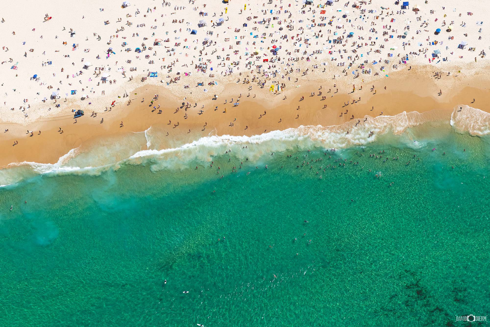 Vertical aerial view of Bondi Beach on a perfect summer day with crowds and turquoise water, Sydney NSW