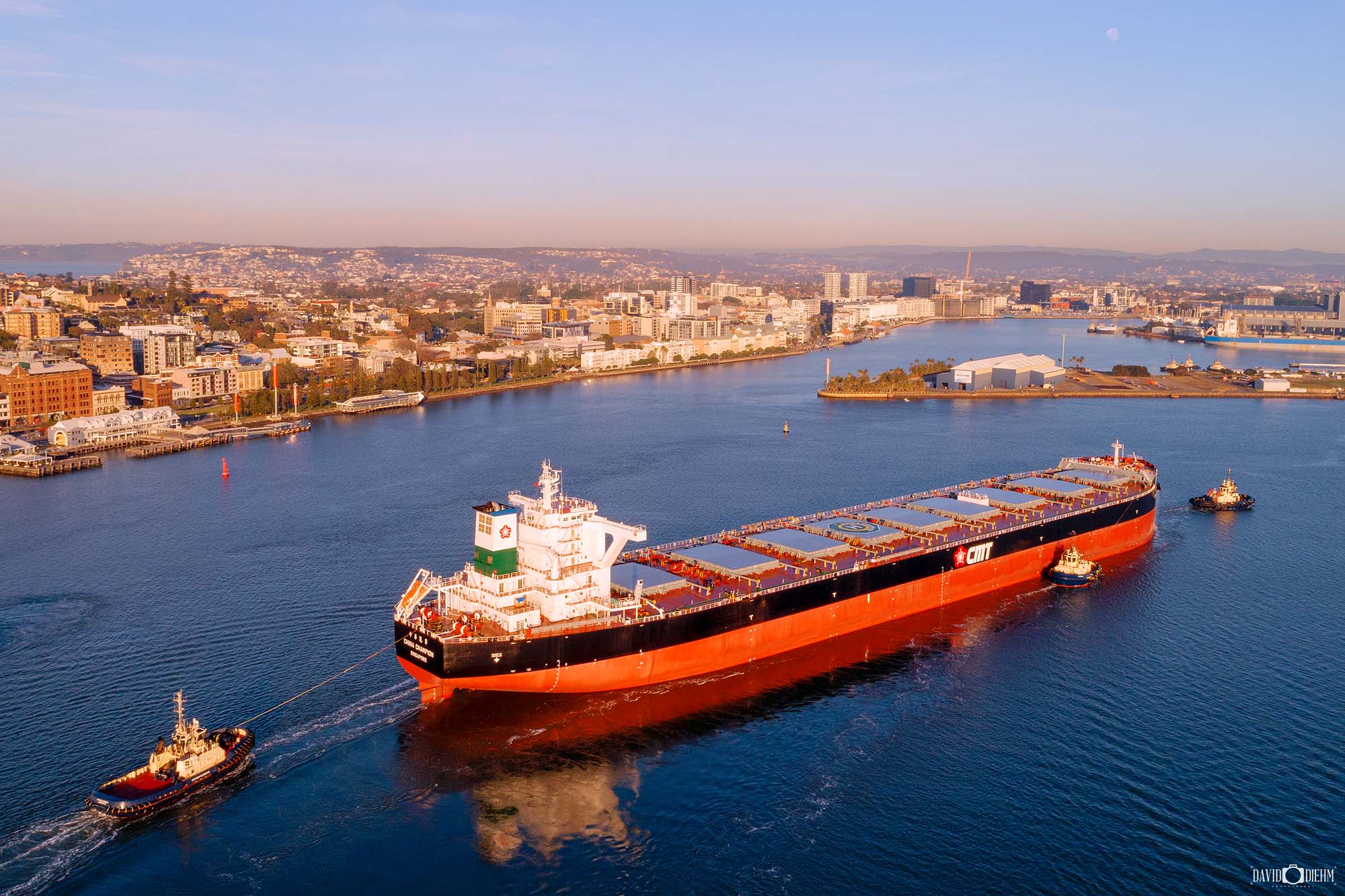Coal carrier ship moving through Newcastle Harbour toward the berthing channel for loading
