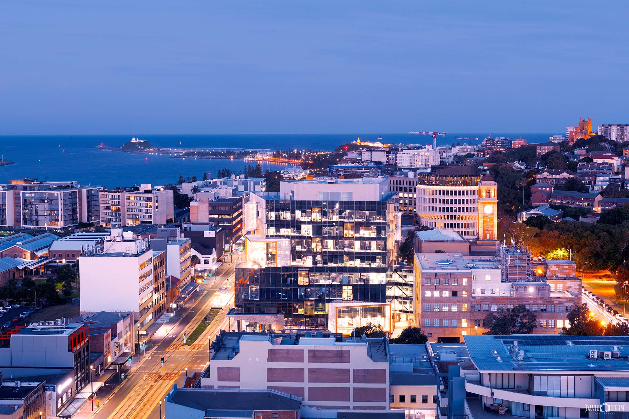 Newcastle city skyline at evening as lights begin to turn on over the harbour and waterfront