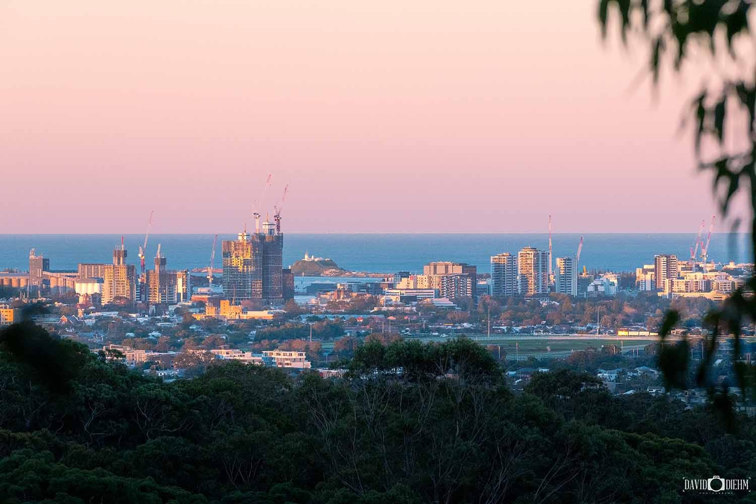 Sunset view from New Lambton Heights Lookout overlooking the Newcastle skyline, Nobbys Lighthouse and the Pacific Ocean.