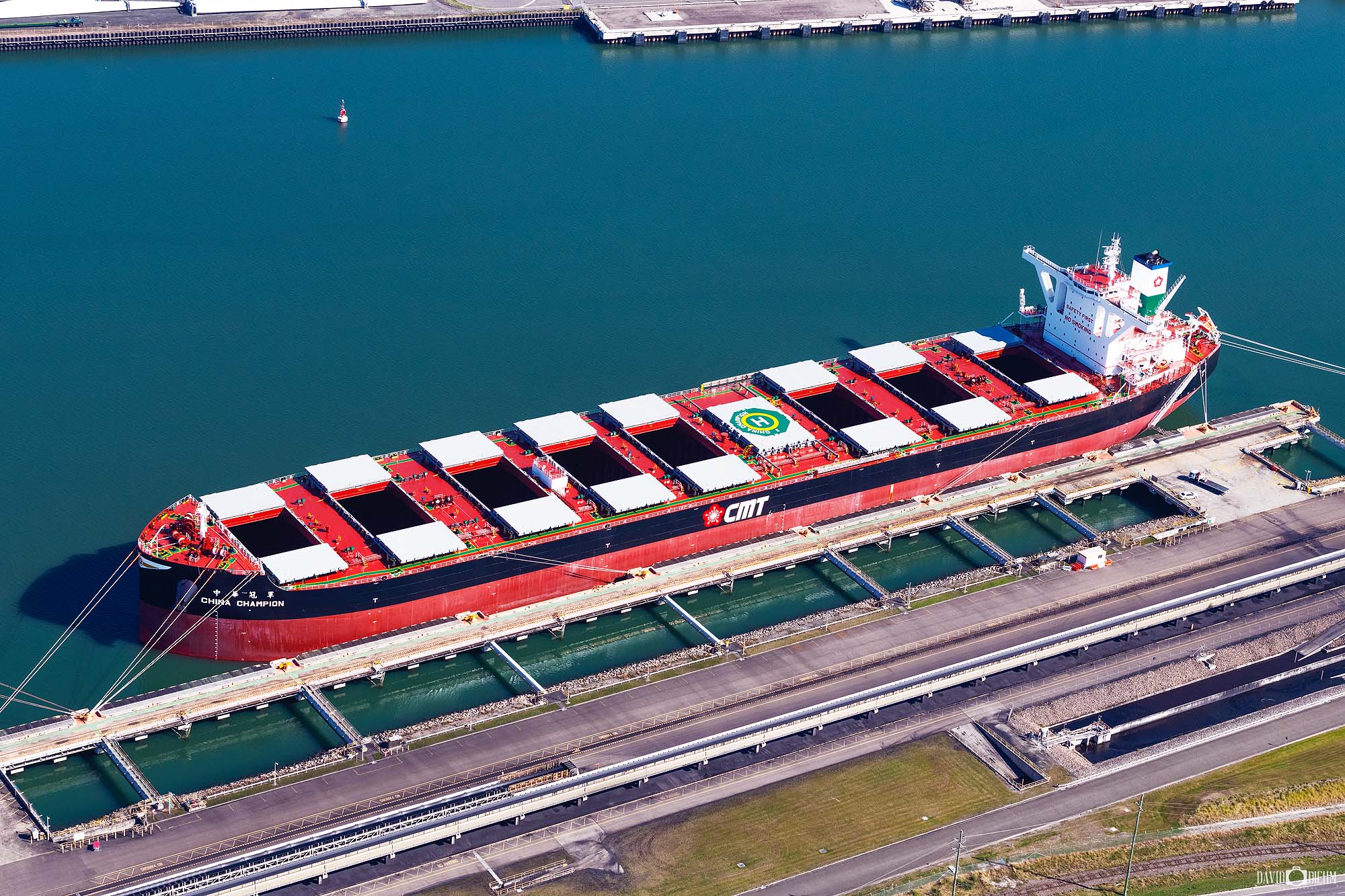 Aerial helicopter view of coal ships loading in the berthing channel at Newcastle Harbour, Australia’s major coal export port