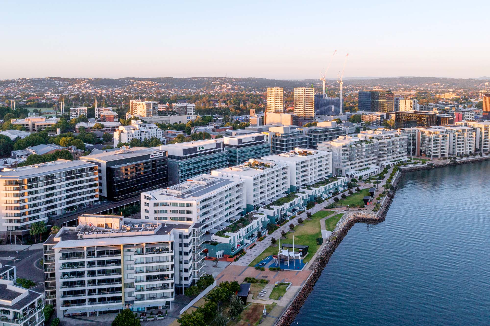 Aerial view of Honeysuckle residential development along Newcastle harbour foreshore showing waterfront apartments and urban growth