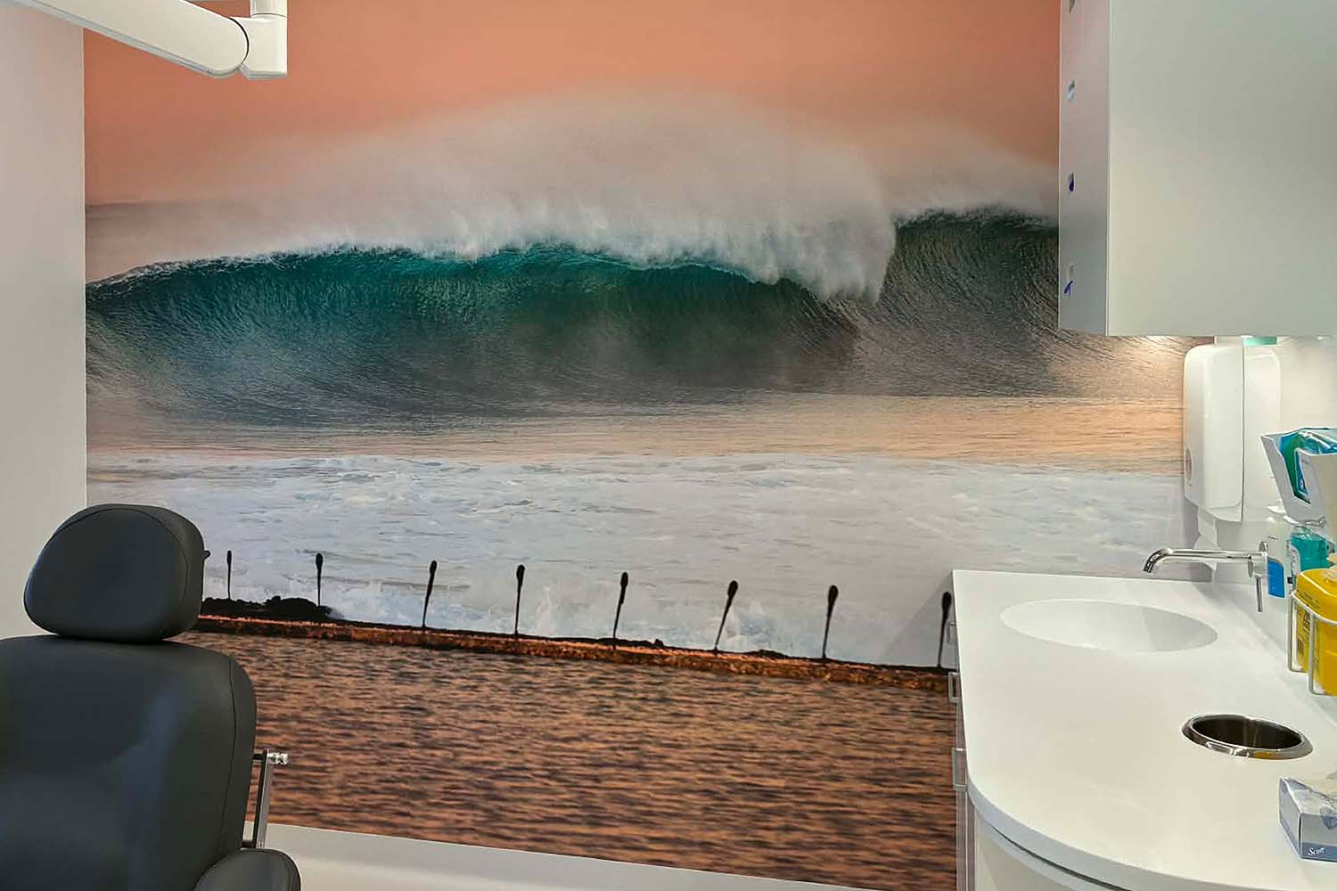 Newcastle beach wave photograph displayed as full wall art in a dentist clinic available for commercial image licensing Newcastle Australia