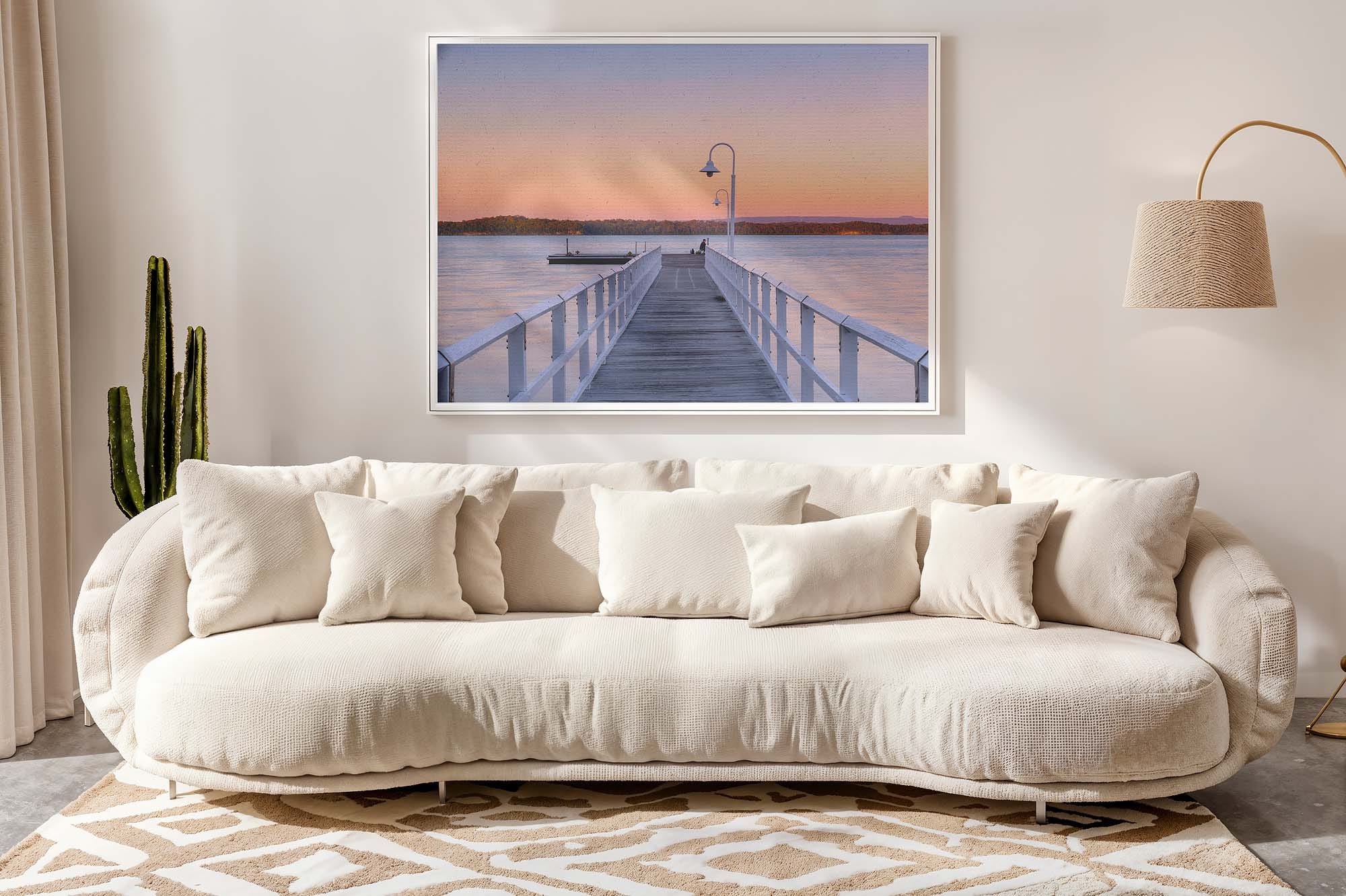 Landscape wall art above sofa demonstrating horizontal orientation in living room design