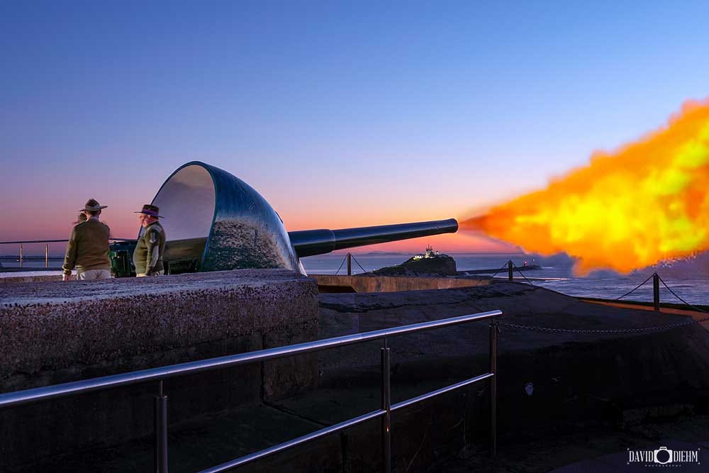 Historic cannon firing demonstration at Fort Scratchley Newcastle with Nobbys Lighthouse in the background