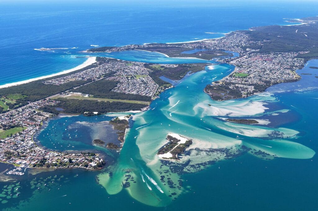 Scenic aerial view of Lake Macquarie NSW featuring Australia's largest coastal saltwater lake, beaches, waterways, and surrounding coastline.