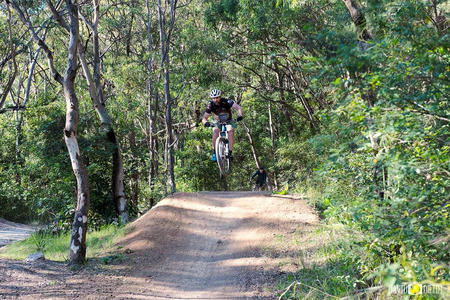 glenrock-mountain-bike-jump.jpg A mountain biker jumping over a dirt feature on the Glenrock mountain bike trails.