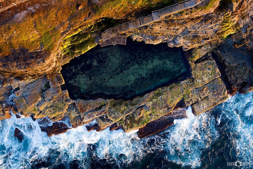 Aerial view of the historic Bogey Hole Newcastle showing Australia's oldest ocean bath carved into the rocky coastline