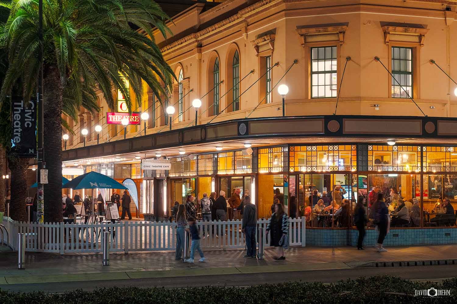 newcastle-civic-theatre-exterior-night.jpg People arriving at Newcastle Civic Theatre at night with the illuminated heritage façade and theatre café in Newcastle, NSW.
