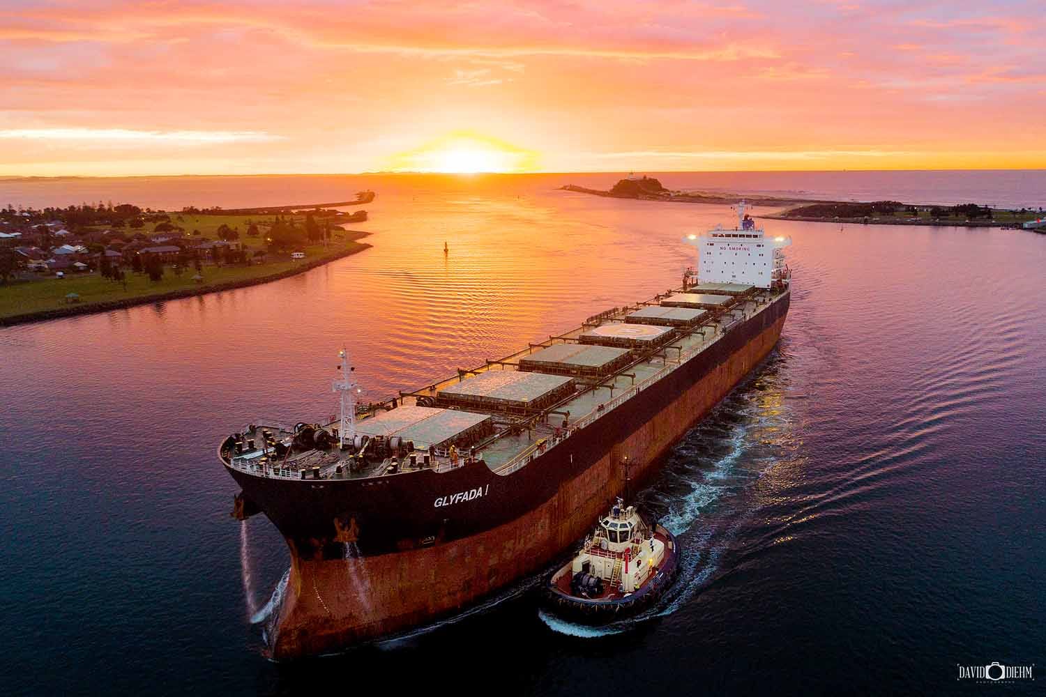 newcastle-harbour-sunrise-coal-ship.jpg A coal ship entering Newcastle Harbour at sunrise with Nobbys Headland in Newcastle, NSW.