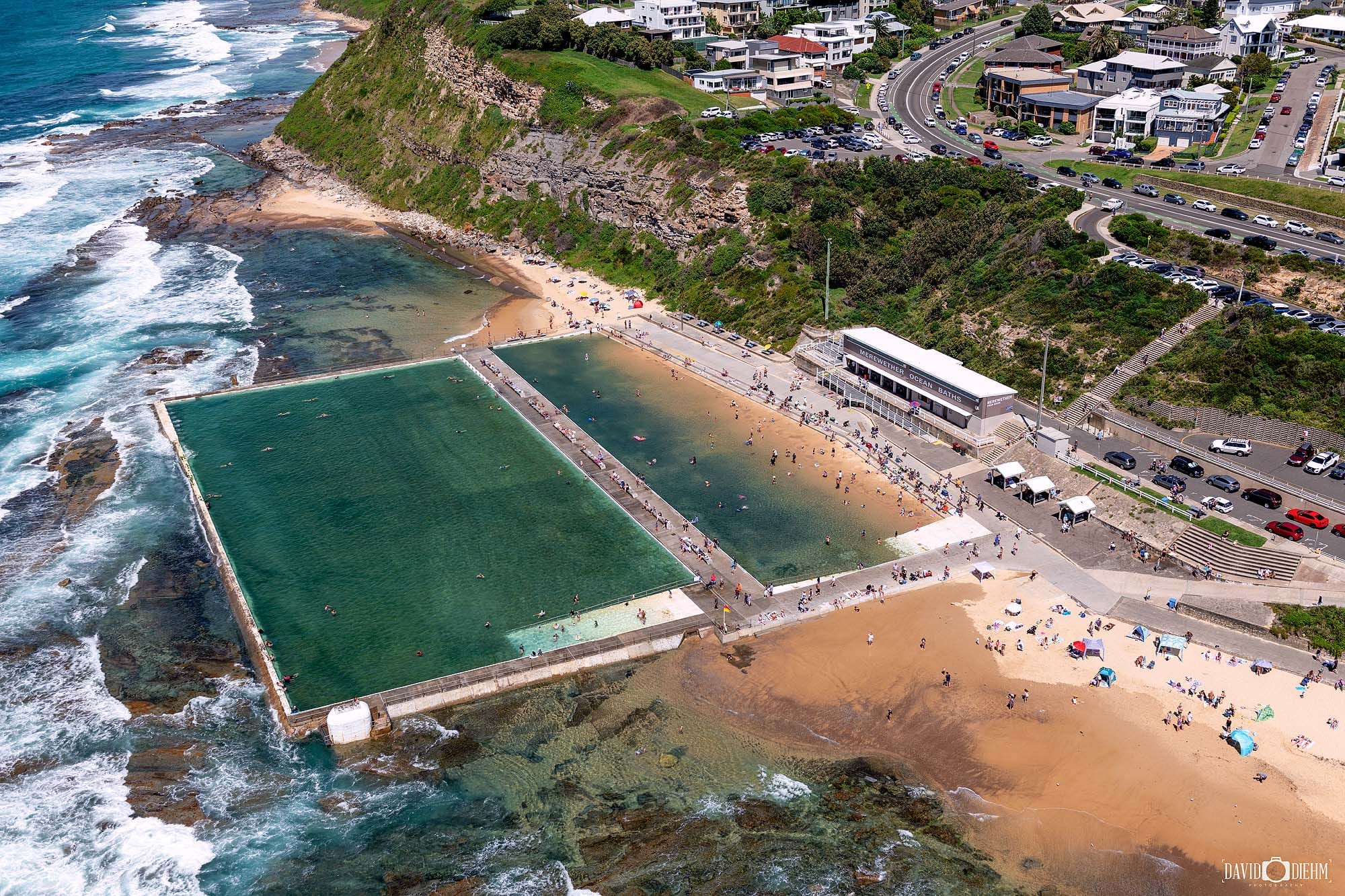 Aerial view of Merewether Ocean Baths and Merewether Beach showcasing Newcastle's iconic coastal attraction