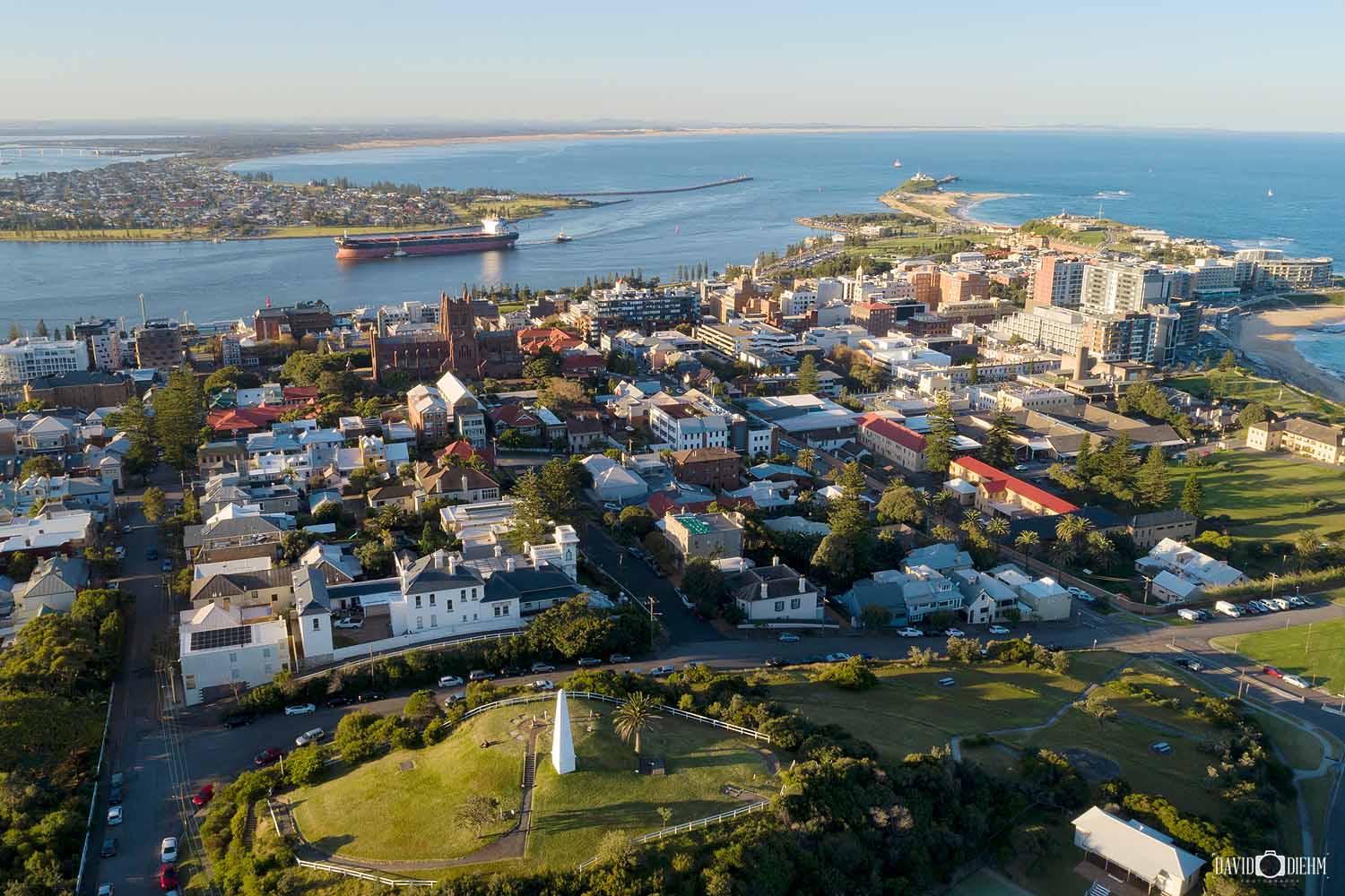 newcastle-obelisk-aerial.jpg Drone view of The Obelisk overlooking Newcastle CBD, Newcastle Harbour and Nobbys Lighthouse.