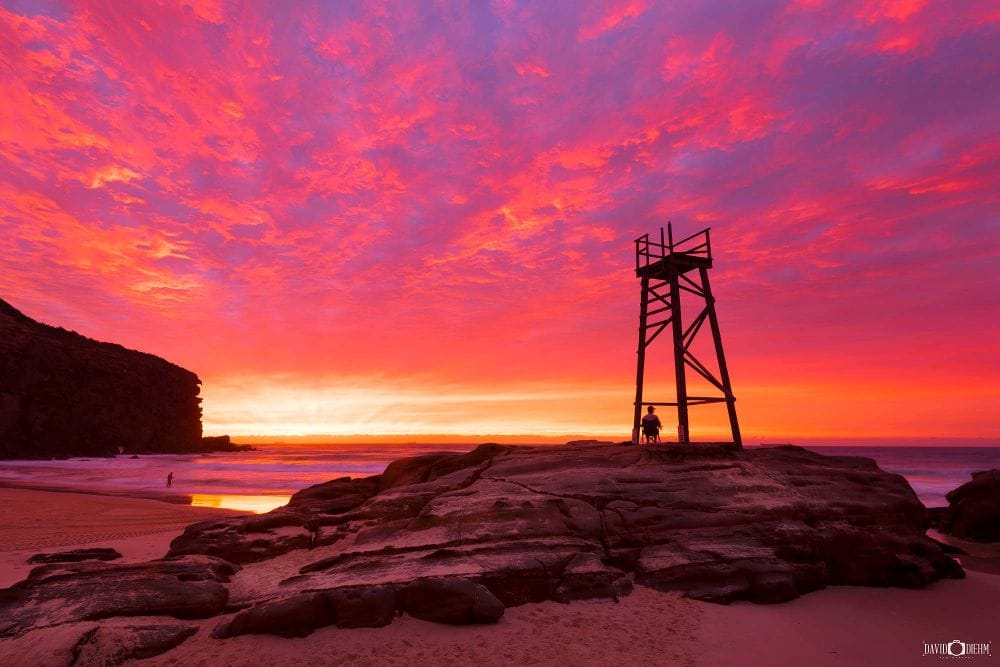 Historic Redhead Shark Tower silhouetted against a spectacular sunrise over Redhead Beach NSW