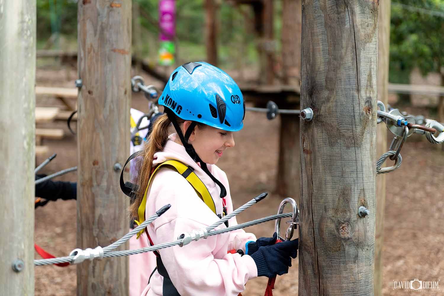 wildnets-adventure-park-newcastle-high-ropes.jpg Visitor wearing a helmet and harness on the high ropes course at WildNets Adventure Park Newcastle.