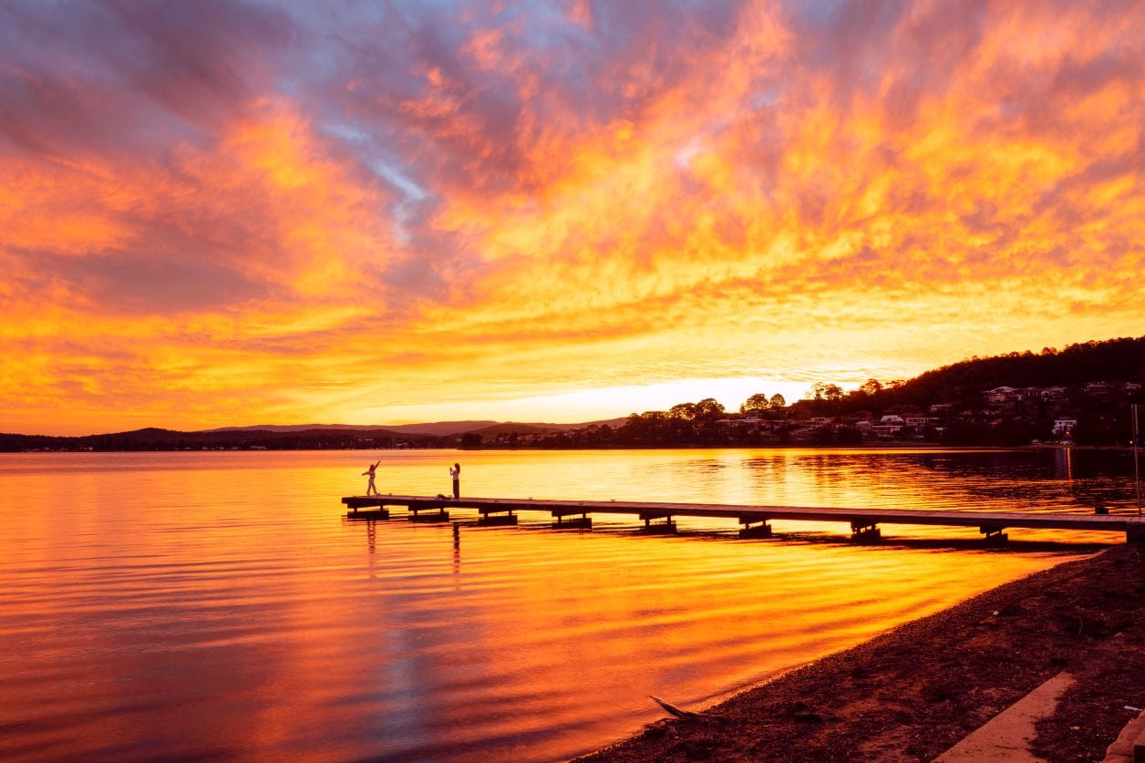 Sunset over the Warners Bay jetty with reflections across Lake Macquarie NSW