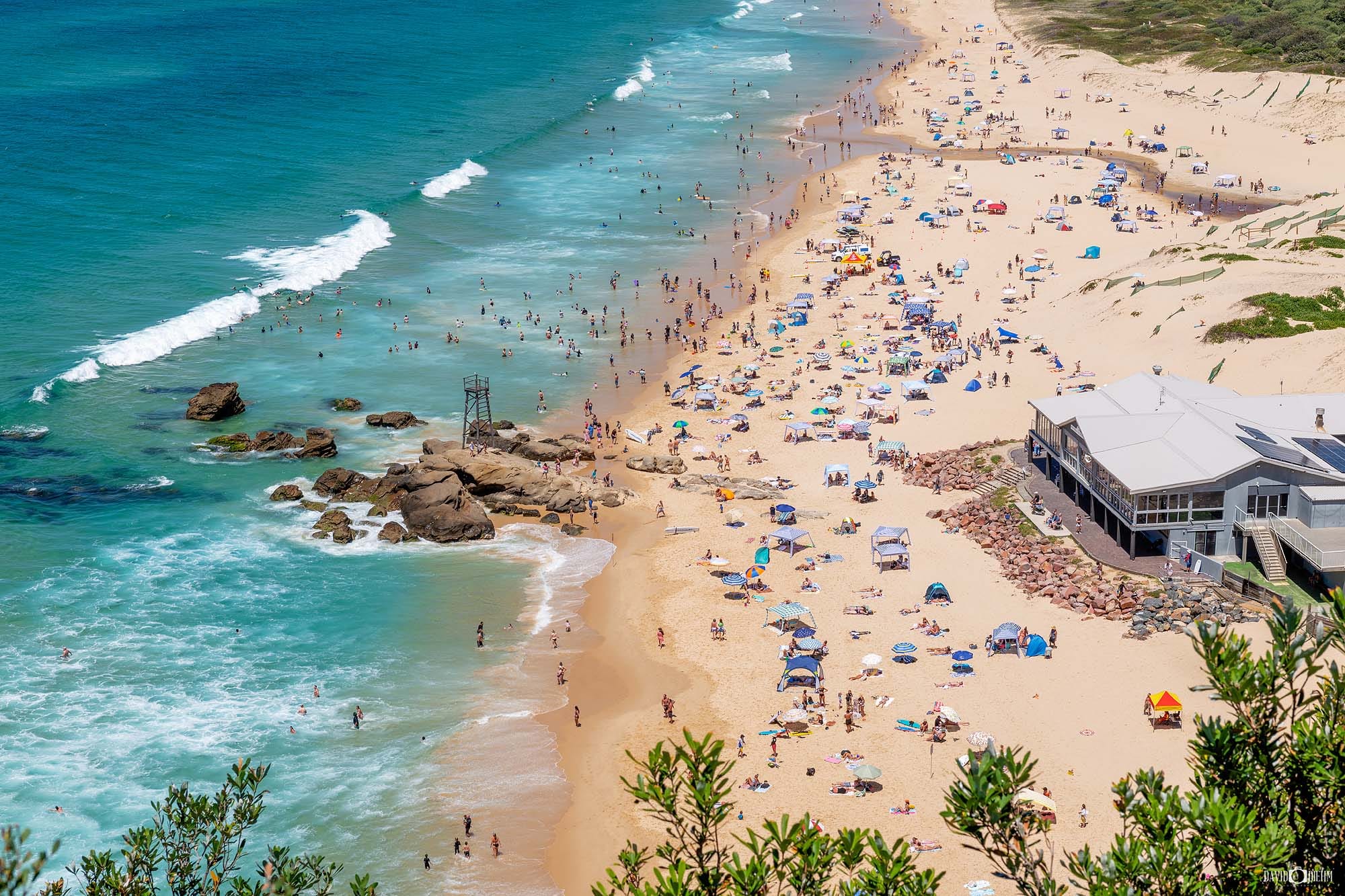 Families enjoying a summer day at Blacksmiths Beach, one of the best beaches in Lake Macquarie NSW.