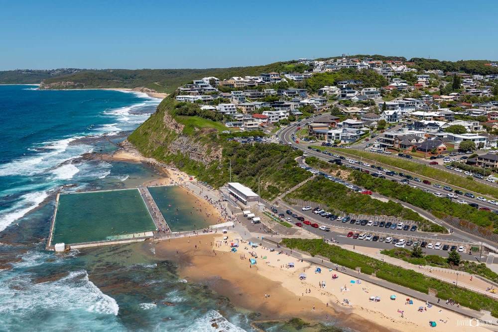 Aerial photograph of Merewether Ocean Baths, Robinson Reserve and the Newcastle coastline in NSW.