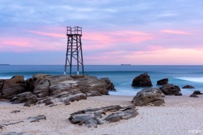 Redhead Shark Tower overlooking the coastline beneath soft sunset colours at Redhead Beach NSW