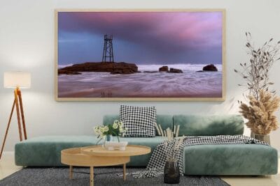 Storm clouds gathering over the Redhead Shark Tower at sunset on Redhead Beach NSW.