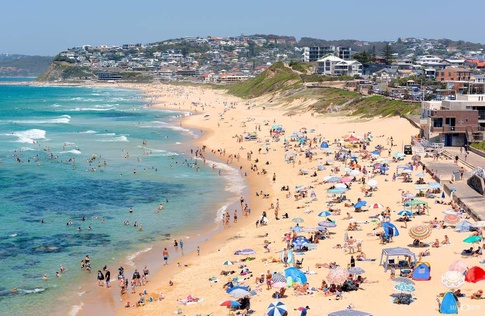 Summer crowds enjoying Bar Beach viewed from Ronnie Watts Lookout in Newcastle NSW.