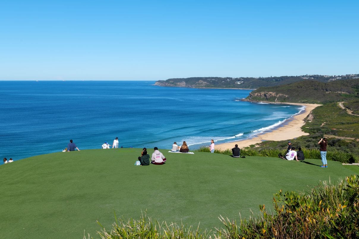 Visitors enjoying the panoramic coastal views from Hickson Street Lookout overlooking Burwood Beach and Glenrock State Conservation Area in Newcastle NSW.