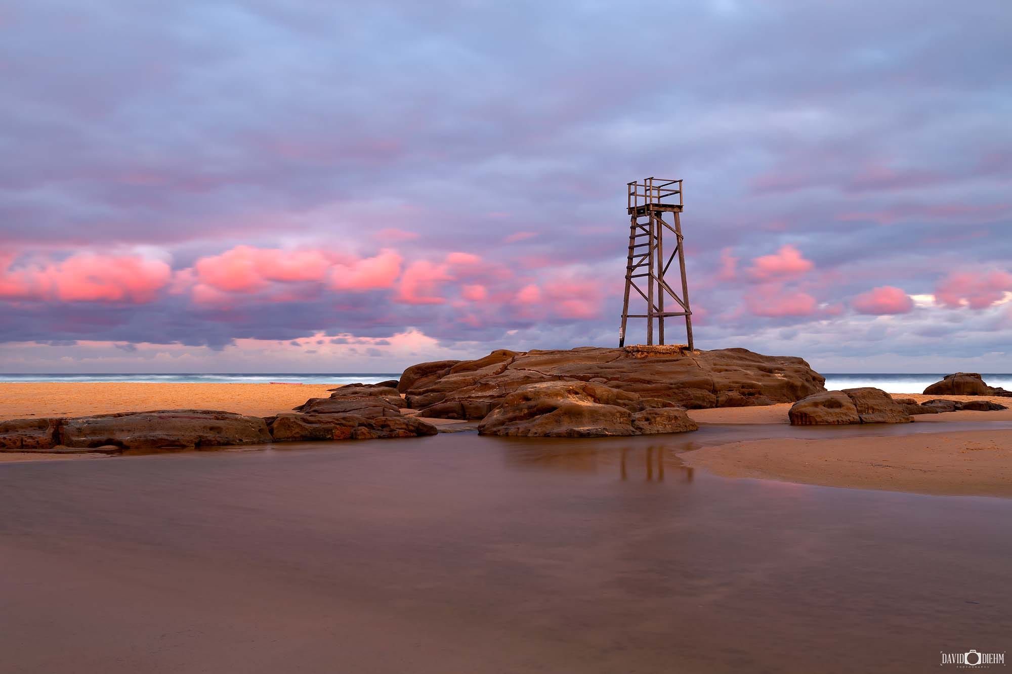Peaceful sunset colours over the coastline and shoreline at Redhead Beach NSW.