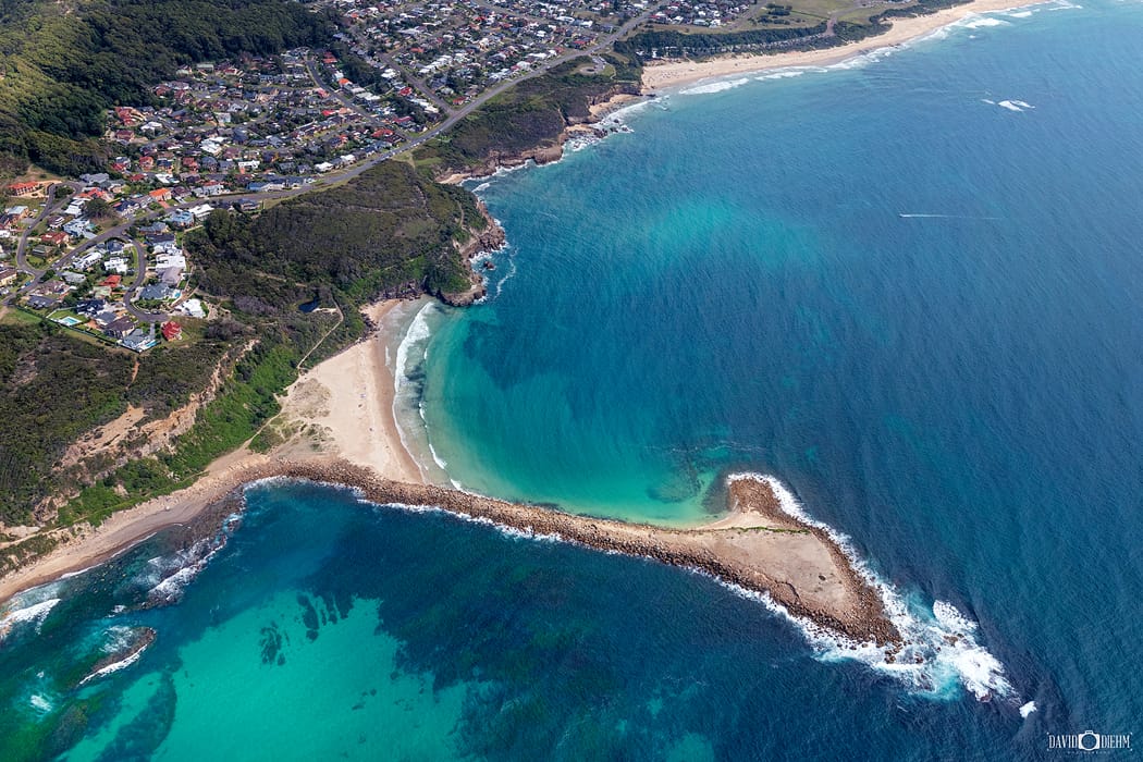 Aerial view of Spoon Rocks Beach showing protected bay and turquoise water near Newcastle and Lake Macquarie