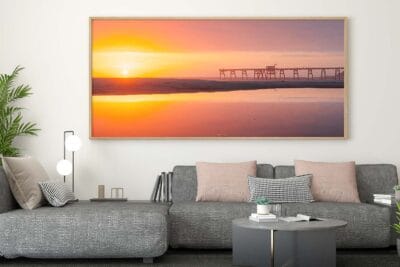 Sea of Glass wall art featuring a panoramic sunrise reflection at Catherine Hill Bay displayed in a modern home.
