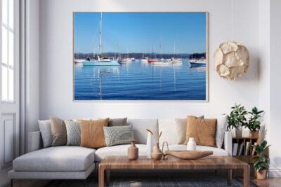Boats reflected in calm waters beneath clear blue skies on Lake Macquarie NSW