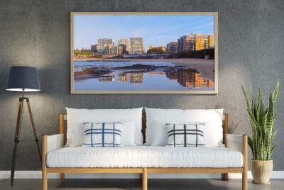 "Newcastle Reflected wall art featuring a sunrise reflection at Newcastle Beach displayed in a modern living room
