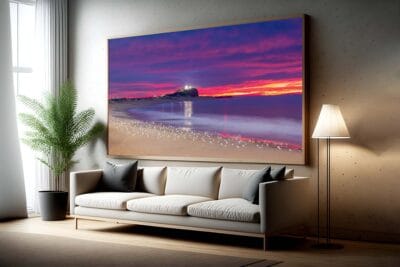 Large framed wall art featuring a flock of seagulls at sunrise on Nobbys Beach, Newcastle, displayed in a modern living room interior.