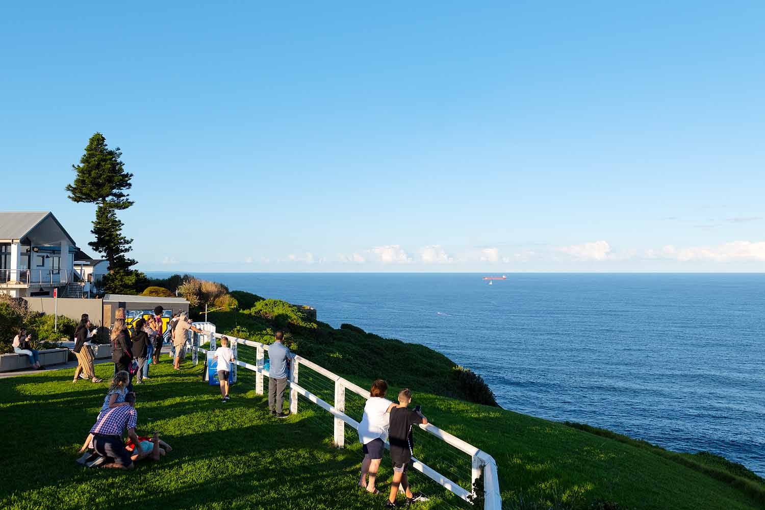 Visitors whale watching from Strzelecki Lookout overlooking the Pacific Ocean in Newcastle NSW.